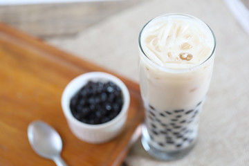 Taiwan iced milk tea fresh drink served with bubble boba sweet drink and boba refill in white small bowl 