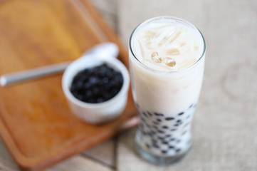 Taiwan iced milk tea fresh drink served with bubble boba sweet drink and boba refill in white small bowl 
