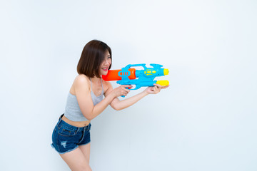 Asian sexy woman with gun water in hand on white background,Festival songkran day at thailand,The best of festival of thai,Land of smile