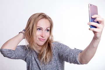 Fototapeta premium beautiful blondy lady taking selfie with her smart phone