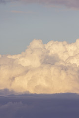 powerful and active white cumulonimbus cloud in a deep blue sky
