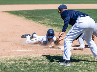 Young boys playing in high school baseball game
