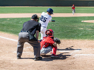 Young boys playing in high school baseball game