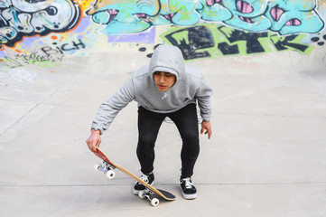 young skater doing jump trick at skate park .