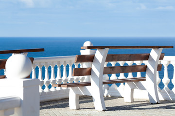 White bench for relaxing on the promenade overlooking the sea. Without people © rimmdream