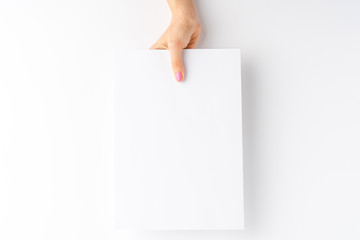 Woman’s hand showing white paper with copyspace. Close up