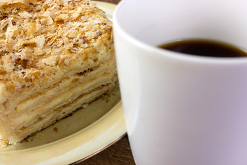 puff pastry Napoleon cake with a cup of coffee