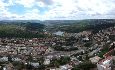 Fototapeta na wymiar Aerial view of Maalot , Israel with water and communication tower in sight 