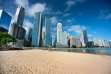 Chicago cityscape across the sand of Ohio Street Beach on Lake Michigan and Lake Shore Drive in...