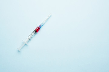 Syringe with a dose. Portion injection on a light background.