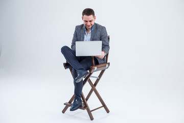 Male teacher director businessman sitting on a chair studying documents. He is looking at the...