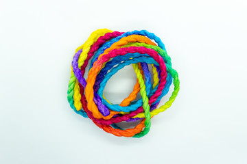 The rope is dyed with various colors, laid on a white background