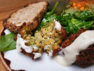 Very closeup cut falafel with bread and some vegetables