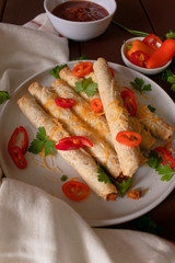 Cheese and chicken taquitos with jalapeño