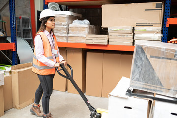 Full Length Of Attractive Female Worker At Factory