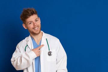 Attractive doctor with white lab coat on a blue background