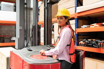 Female Supervisor Making Eye Contact While Using Machinery