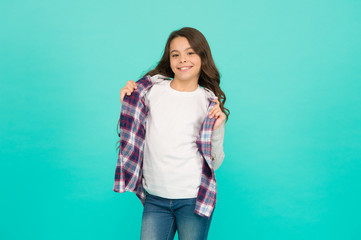 Fototapeta na wymiar Pleasant emotions. stylish teen girl turquoise background. pretty teen girl with long hair, fashion. kid hairdresser concept. Back to school. Studio shot of glad child. childhood happiness