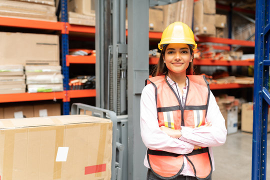 Female Worker In Protective Workwear At Warehouse