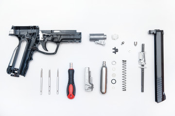 pistol parts neatly folded on a white background