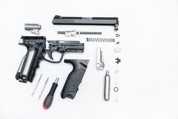 pistol parts neatly folded on a white background