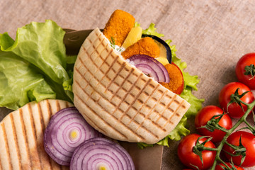 Pita doner kebab with green salad, tomatoes cherry, potato free, grilled fish sticks . Street food....