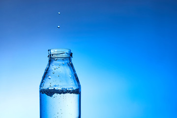 Pouring water into glass.