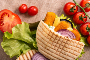 Pita doner kebab with green salad, tomatoes cherry, potato free, grilled fish sticks . Street food....
