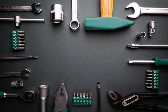 Set of tools over black background, top view with space for text