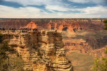 Tourists overlook the Grand Canyon from Mather Point tourist stop in the South Rim of the Grand Canyon National Park.