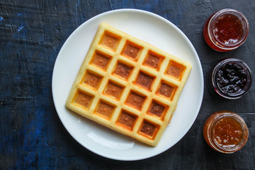 Belgian or Viennese waffles (delicious sweet dish, dessert snack) menu concept. background. top view. copy space for text