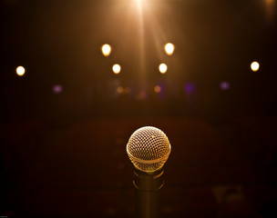microphone on stage with spotlight on stage