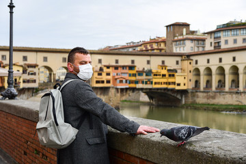 Coronavirus Covid-2019 in Italy. man in  protective medical mask in the historic center of Florence. empty Italian streets without tourists. Coronavirus in Venice Milan Lombardy Rome