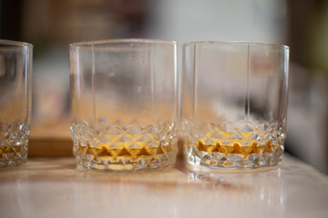 Scotch glasses with scotch kept on a table. Object photography.