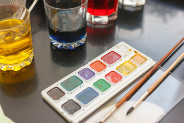 glasses with multicolored coloring water ant paints. close-up. Easter preparations.