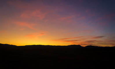 Fototapeta premium Purple sunset sky background. Blue, pink, red sunrise colors. Beautiful yellow, orange evening clouds. Colorful night twilight scene.