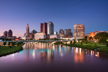 Downtown cityscape looking over the Scioto River and the Discovery Bridge along the Riverfront Park in the city of Columbus Ohio USA