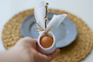 Easter table setting. Egg, plate, napkin. Easter bunny.