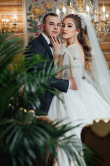 Naklejka premium Сouple newlyweds bride and groom at a wedding day. Wedding couple in home. Sensual love. Happy romantic moments