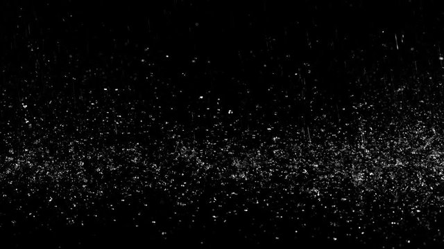 Droplets of rain falling on the surface creating splashes on an isolated background