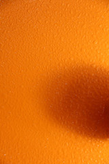 Wet orange background. Bright texture with water drops.