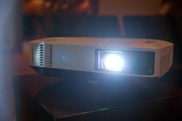 LCD video projector at business conference or lecture in office with copy space. projector on...