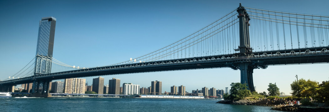 Manhattan Bridge panoramic as seen from the DUMBO area and Pebble Beach in Brooklyn New York USA