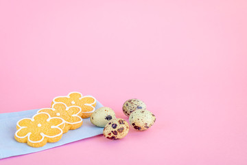 Selective focus to the corn biscuits and quail eggs on a pink background. Copy space.