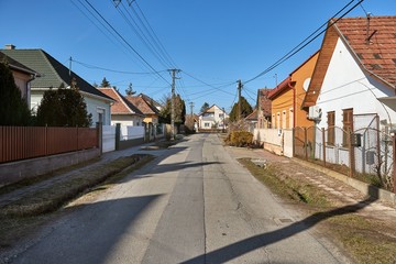 Village street with houses, generic view in Ecser, Hungary