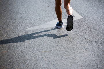Mature man runner feet on asphalt