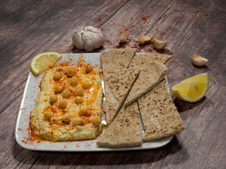 Close-up of classic hummus homemade with pita bread