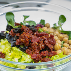 fresh healthy salad with dried tomatoes in the boul