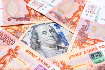 Fototapeta na wymiar American us dollars lying among russian rubles, saving money from devaluation concept
