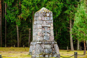 stone monument at the edge of the forest